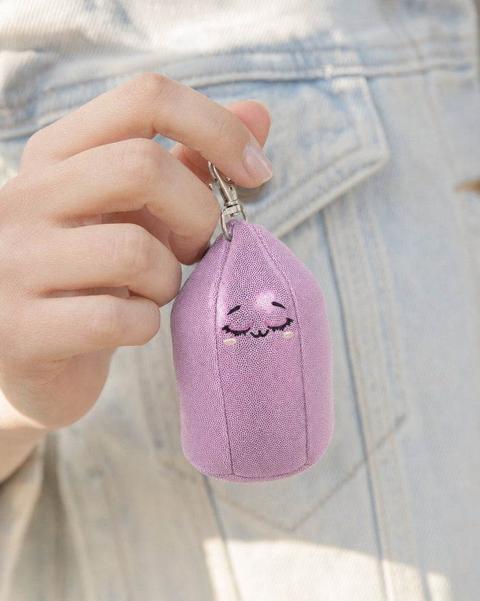 Fingers holding Baby Amy, the lilac amethyst bag charm, by her silver clip