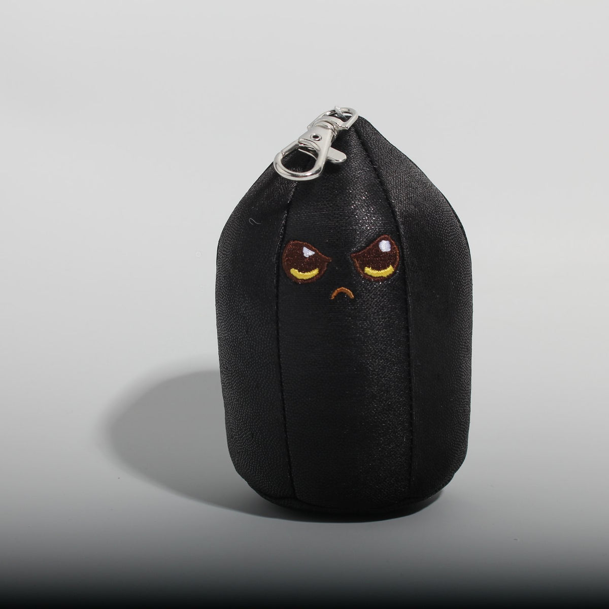 Baby Obie, a plush obsidian bag charm by Crystal Plushie