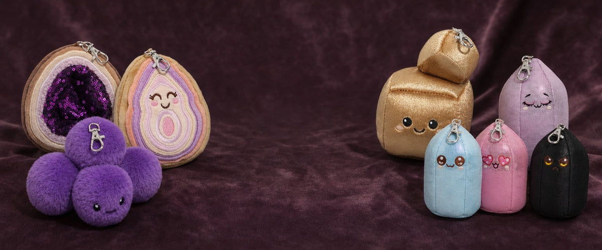 All 8 Crystal Plushie bag charms on plum velvet
