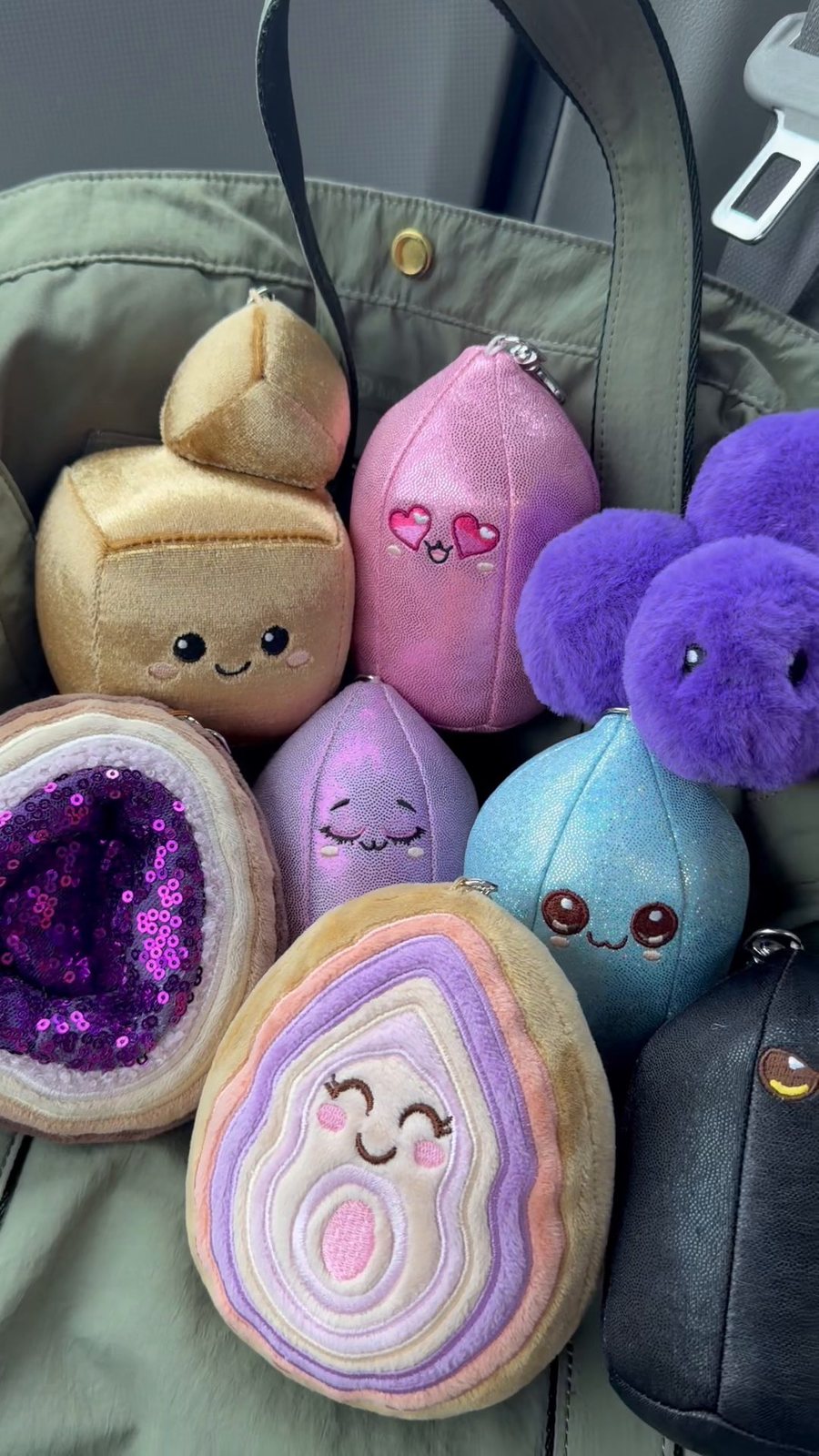 All 8 Crystal Plushie bag charms piled together in a tote bag